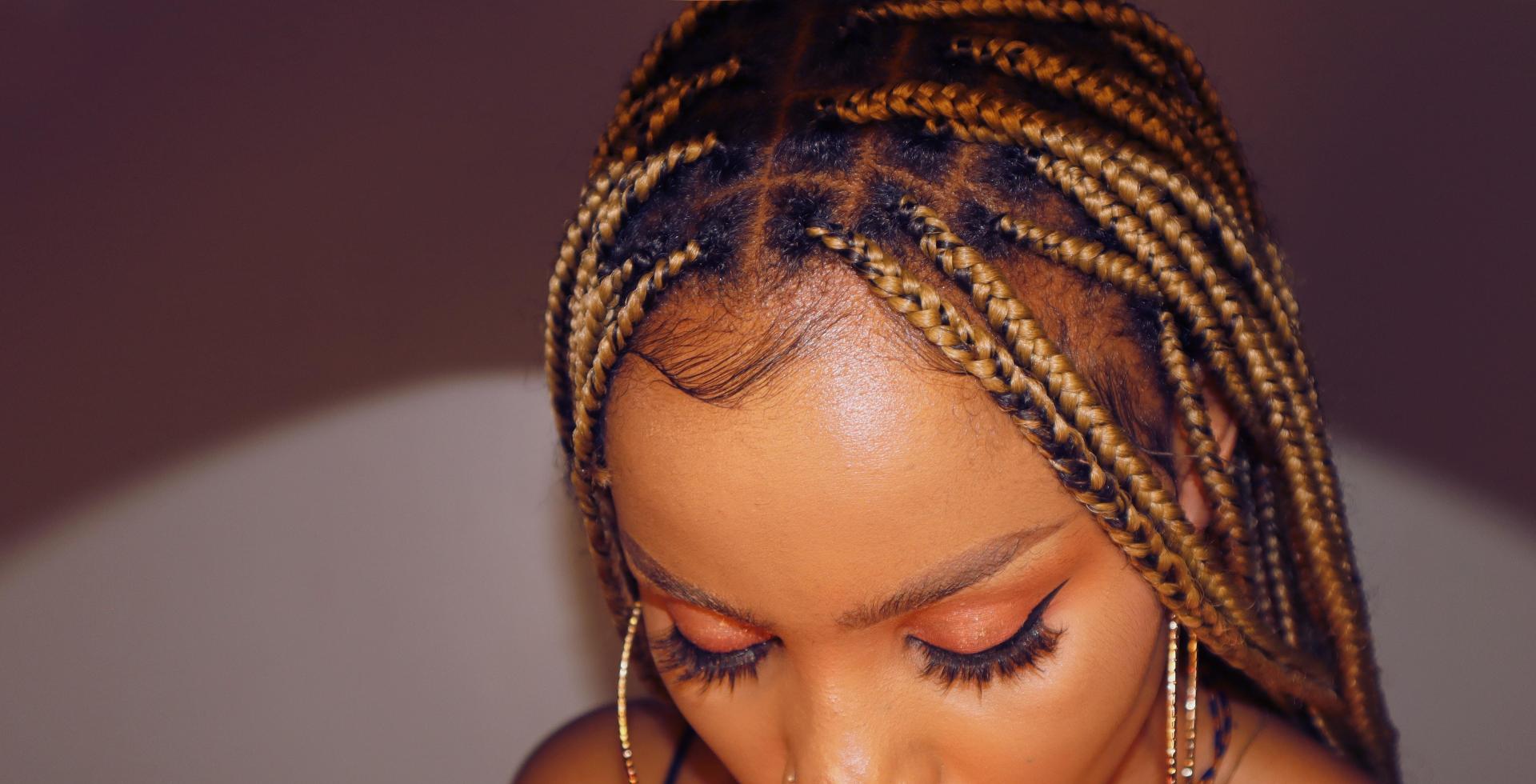 African woman with stunning knotless braids by VIP Braids By Yvonne